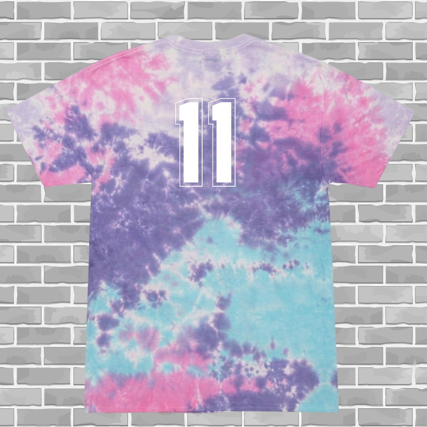Tie-dye t-shirt with number 11 on a brick wall background